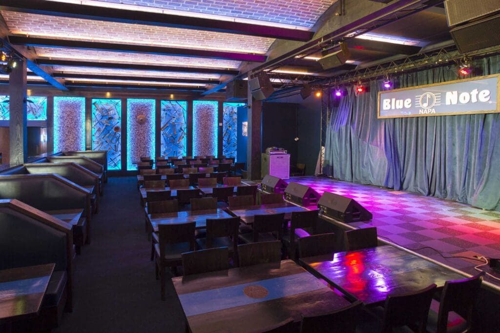 The stage inside Blue Note Napa beneath the venue's sign