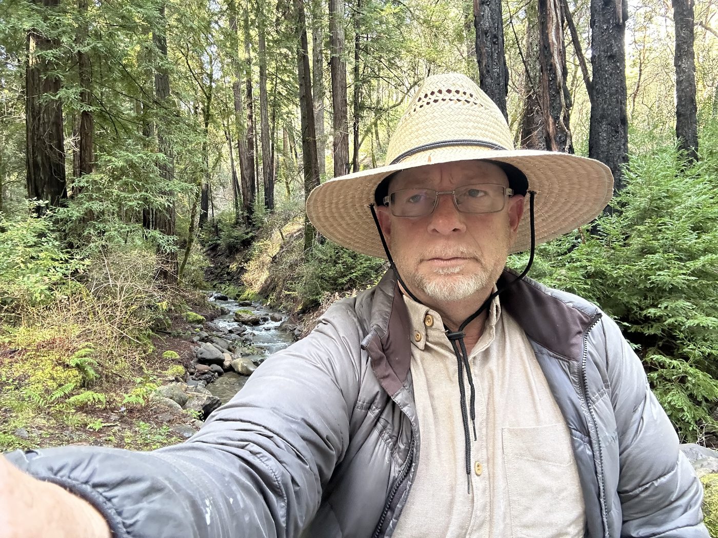 Justin Perkins, founder of Napa Kayak, outdoors by a wooded creek